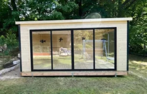 Moderní zahradní chatka s velkými okny na zahradě