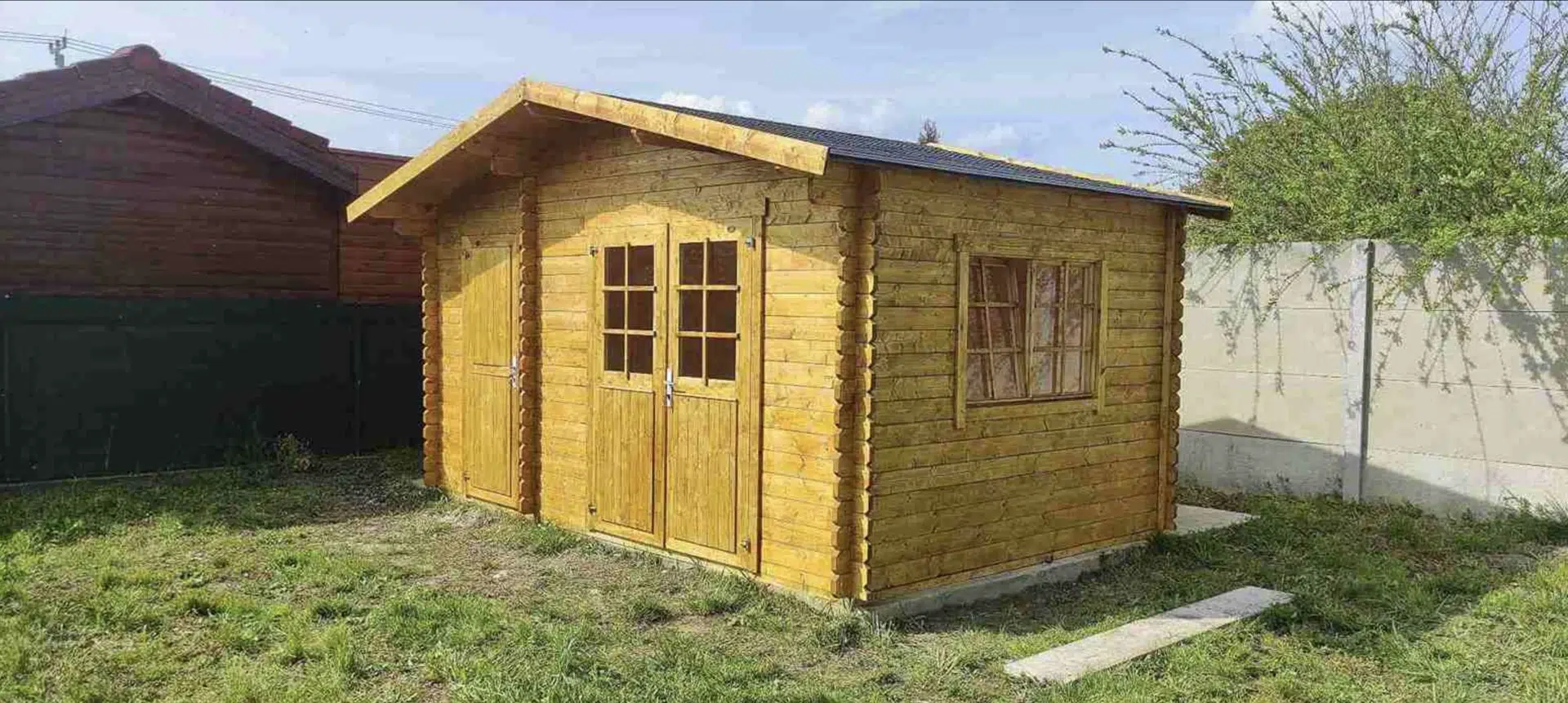 Dřevěný zahradní domek Keila 34 Borkum s širokým vstupem a prosklenými dveřmi.